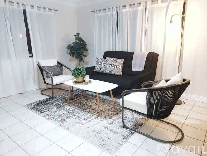 A black and white living room with a sofa, chair, and coffee table.