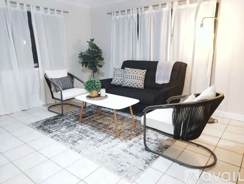 A black and white living room with a sofa, chair, and coffee table.