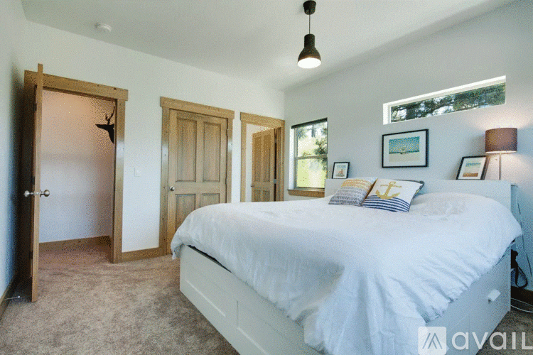 A bedroom with a large bed and a window.