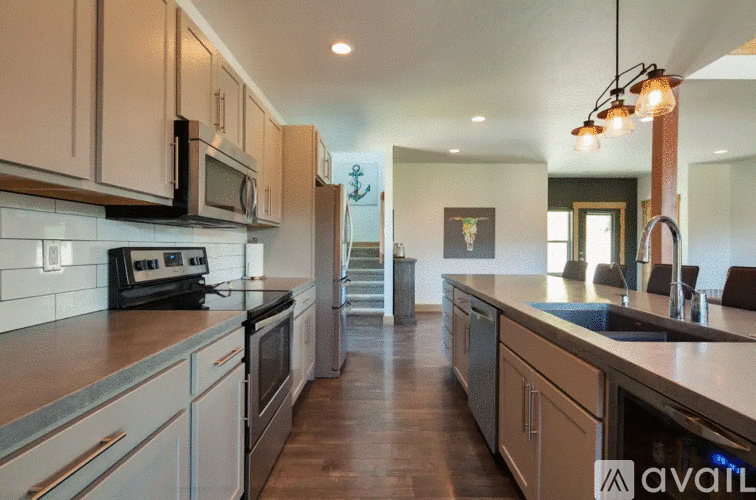 A kitchen with a stove top oven and a microwave.