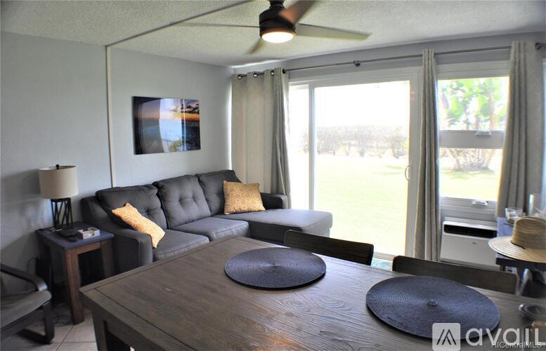 A living room with a grey couch and a wooden table.