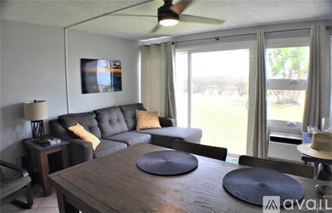 A living room with a grey couch and a wooden table.