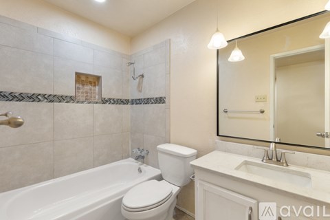 A bathroom with a white toilet, sink, and bathtub.