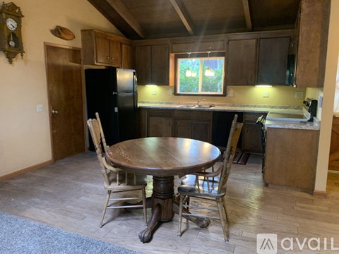 A kitchen with a table and chairs in the middle of the room.