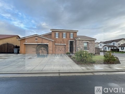 A house with a brown facade and a large front yard is for sale.