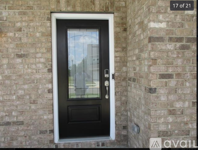 A black door with a glass window is numbered 17 of 21.