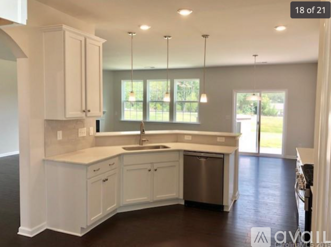 A kitchen with white cabinets and a sink.
