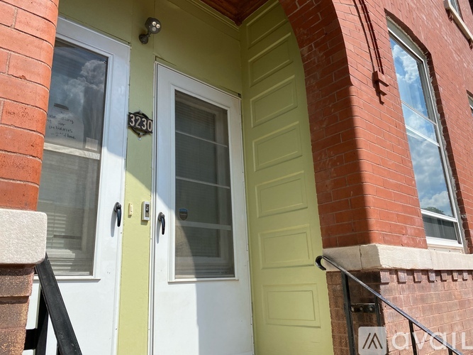 A white door with a glass window is on the right side of a yellow door.