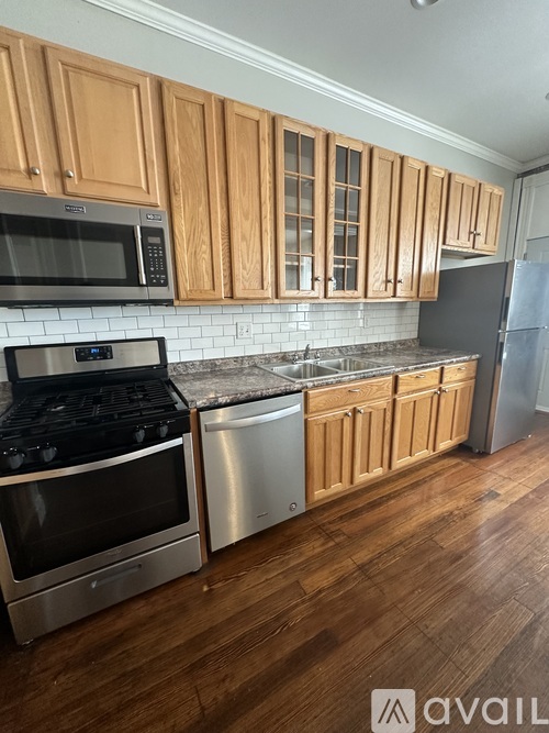 A kitchen with wooden cabinets and stainless steel appliances.