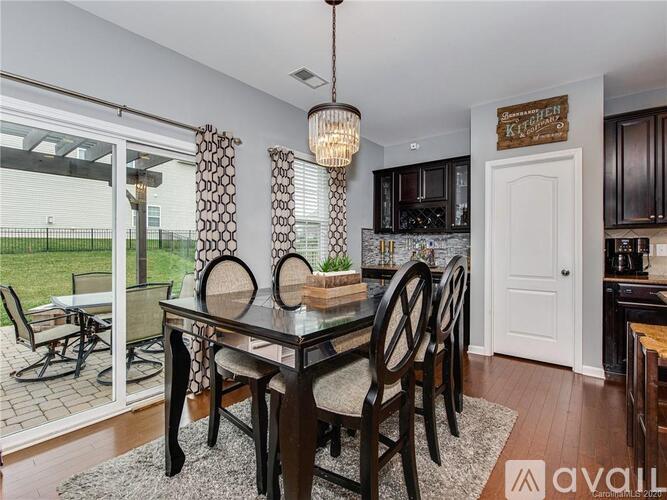 A dining room with a glass table and chairs.