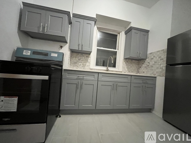 A kitchen with a black oven and a black fridge.
