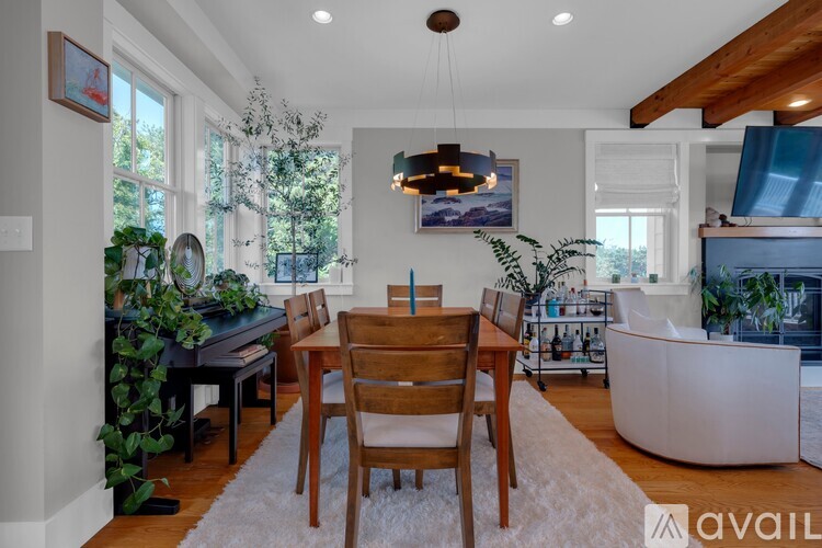 A dining room with a wooden table and chairs.