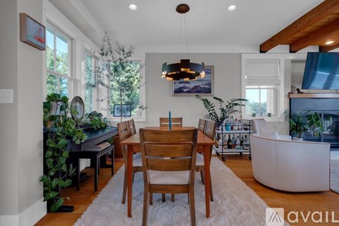 A dining room with a wooden table and chairs.