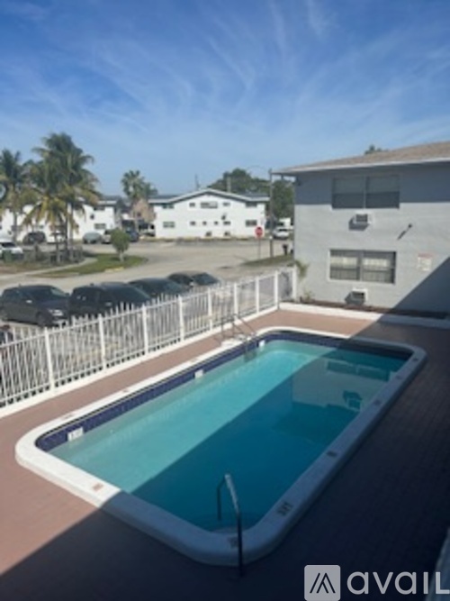 A pool with a white fence around it.