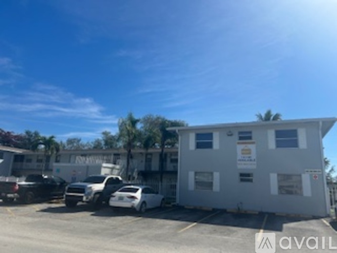 A white building with a sign that says "available" in front of it.