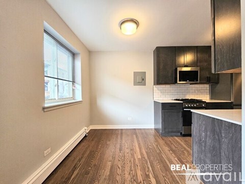 A kitchen with a stove top oven and a microwave.