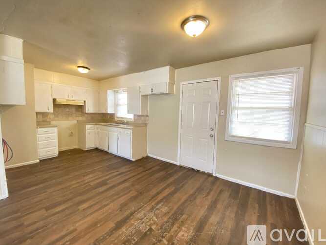 A room with wooden floors and white walls.