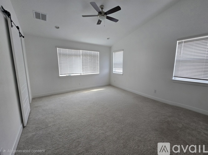 A spacious room with a ceiling fan and two windows with blinds.