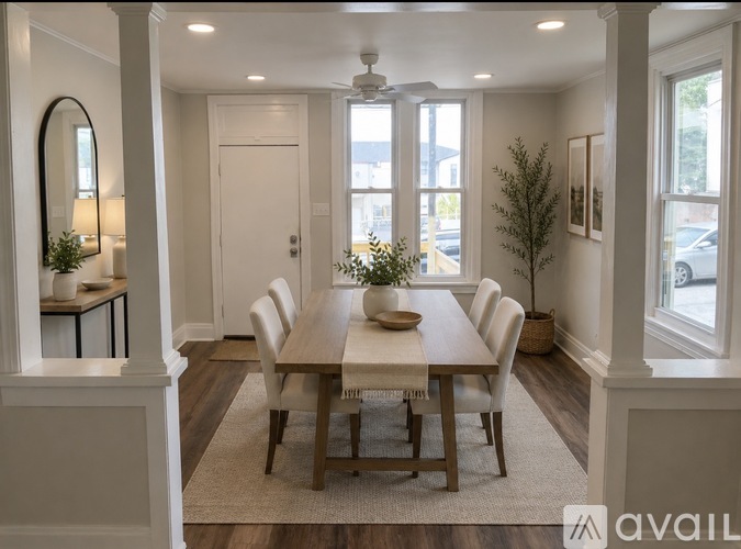 A dining room with a table set for six.