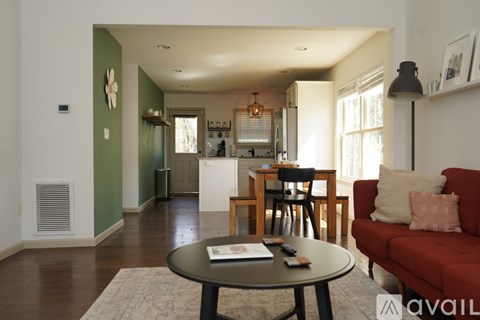 A living room with a red couch and a coffee table.