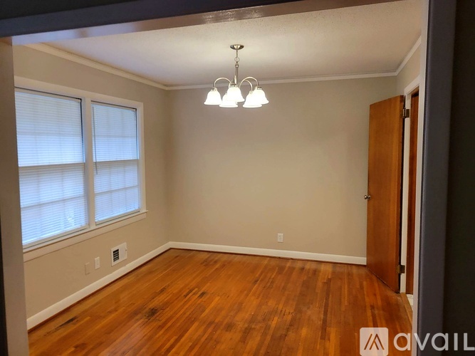 A room with wooden floors and a chandelier.