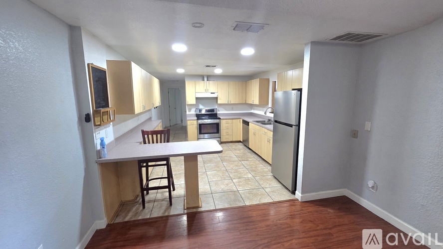 A kitchen with a table and chairs in the middle of the room.