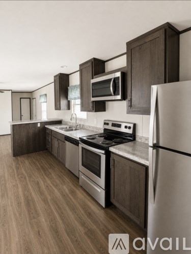 A kitchen with a refrigerator, stove, and oven.