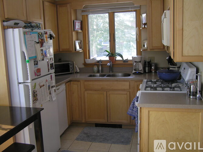 A kitchen with wooden cabinets and a white refrigerator.