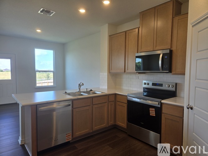 A kitchen with wooden cabinets and stainless steel appliances.