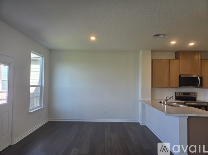 A kitchen with wooden cabinets and a white countertop.