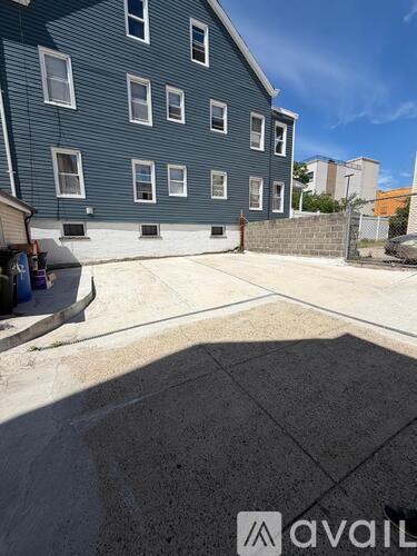 A blue building with a cement area in front.