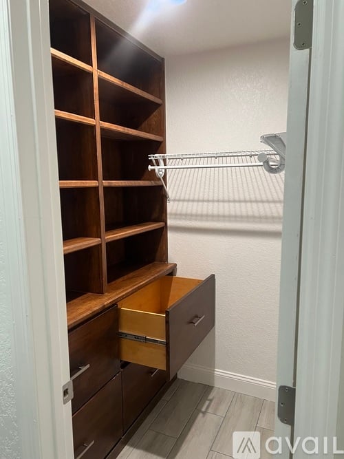 A white closet with a shelf and drawers.