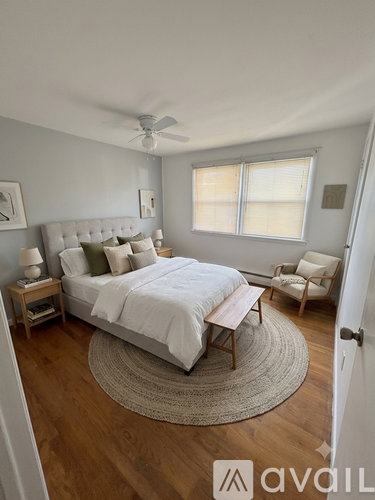 A bedroom with a large bed and a ceiling fan.