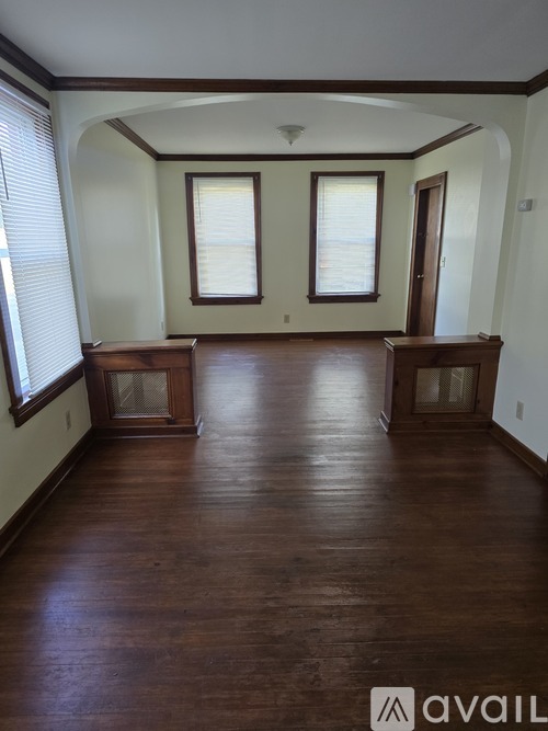 A room with wooden floors and white walls.