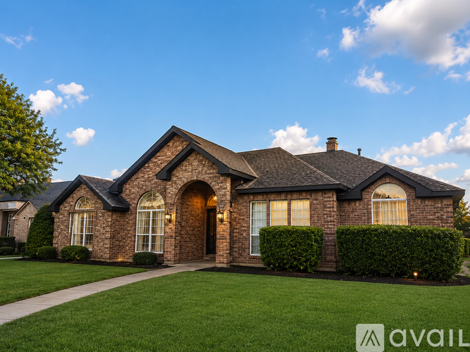 A house with a brick facade and a large front yard.