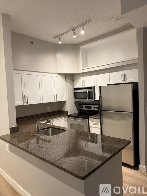 A kitchen with granite countertops and stainless steel appliances.