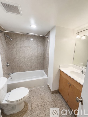 A bathroom with a white toilet, a white sink, and a white bathtub.