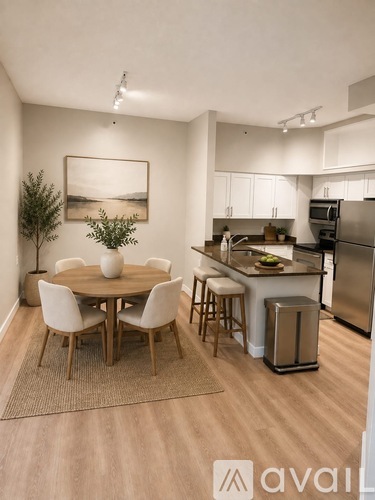 A kitchen with a dining table and chairs.