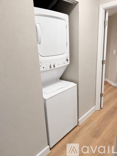 A white washing machine in a small room.