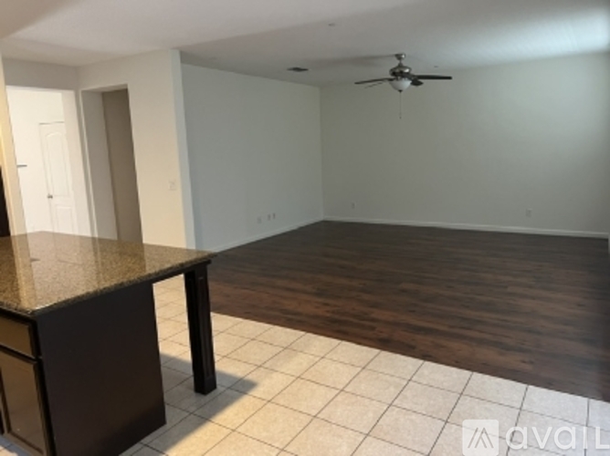 A room with a brown countertop and a ceiling fan.