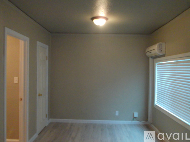 A room with a window and a door.