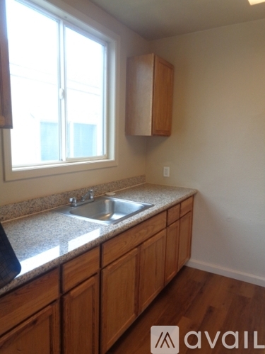 A kitchen with wooden cabinets and a granite countertop.