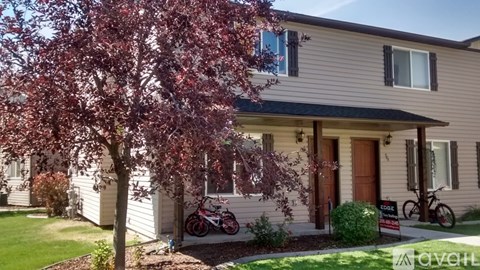 A house with a tree in front of it.