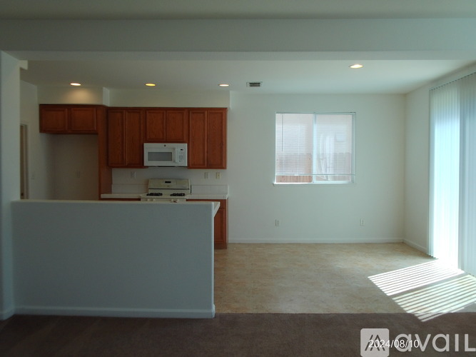 A kitchen with brown cabinets and a white countertop.