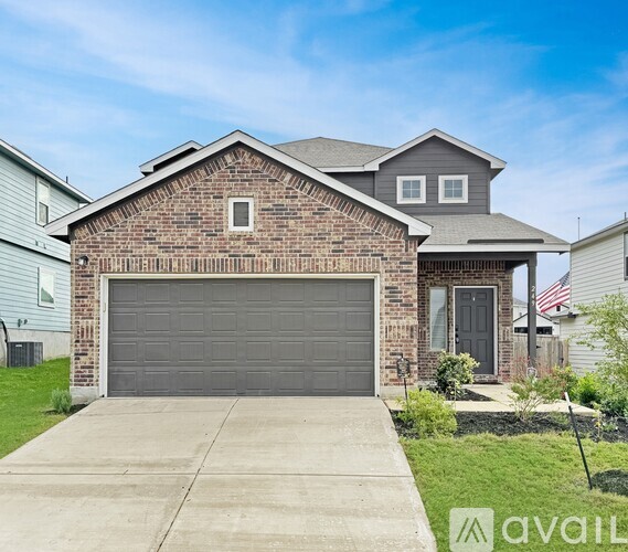 A house with a brick facade and a grey garage door.