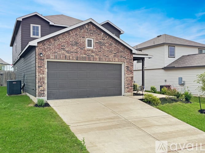 A house with a brick facade and a grey garage door.