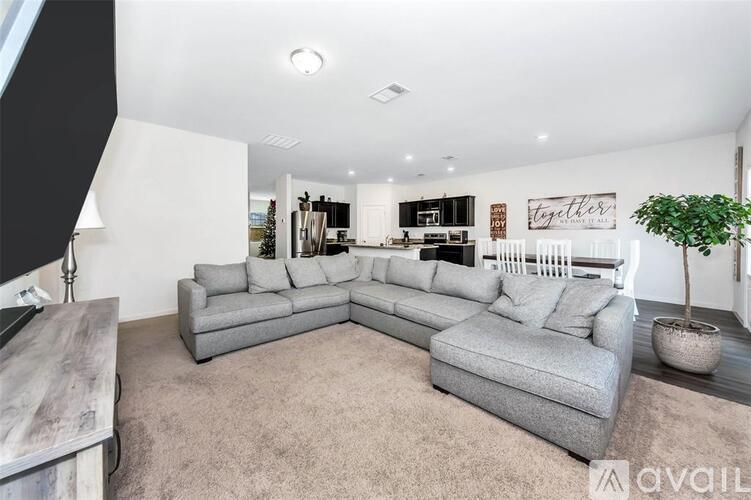 A living room with a grey sectional sofa and a coffee table.