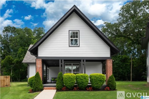 A house with a white exterior and a brick chimney.