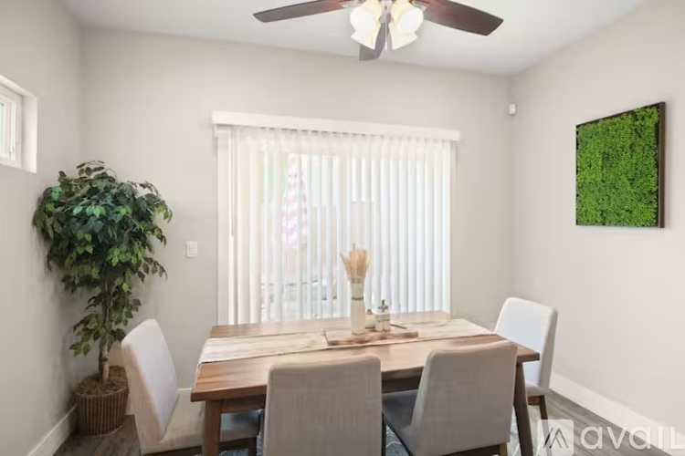 A dining room with a wooden table and chairs.
