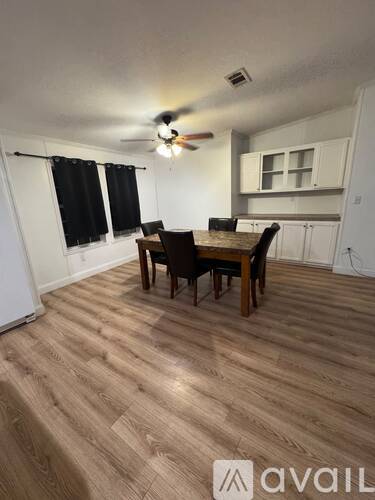 A room with a dining table and chairs in it.